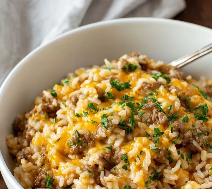 Delicious cheesy ground beef rice casserole served in a baking dish.