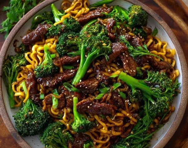Delicious plate of Chinese crispy beef with broccoli noodles served in a bowl
