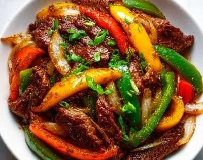 Chinese-style beef stir-fry with onions served in a bowl