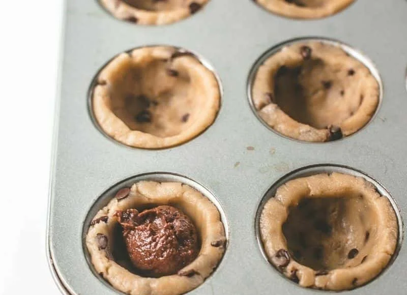 Sliced Chocolate Chip Brownie Tart on a white plate