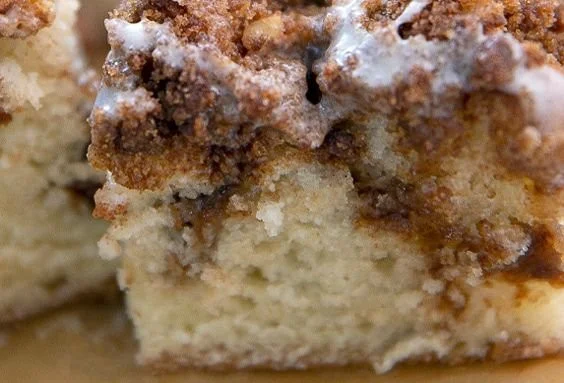 Delicious freshly baked coffee cake with a crumb topping on a rustic wooden table