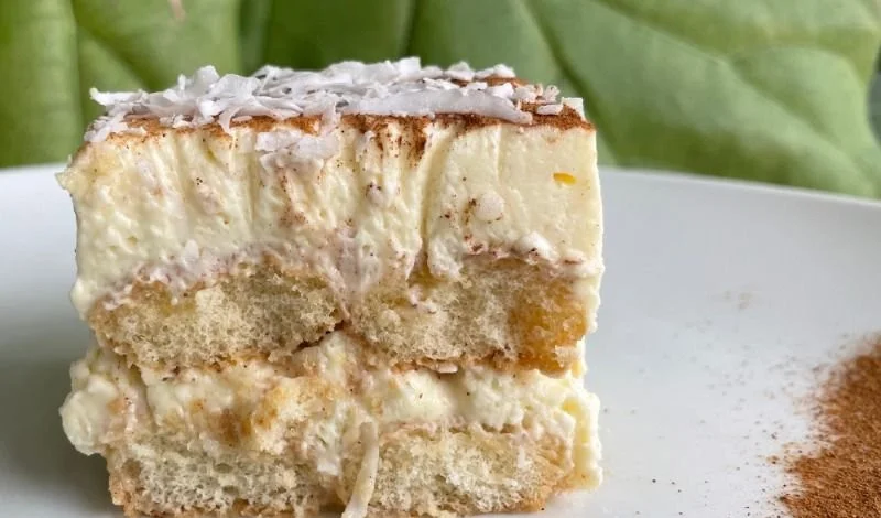 Delicious homemade Coquito Tiramisu topped with cocoa powder and festive decorations.