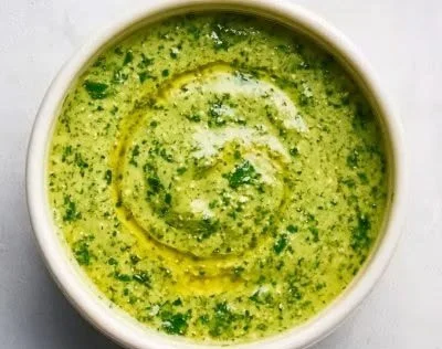 Creamy avocado cilantro lime dressing in a glass bowl with fresh cilantro