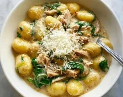 Creamy chicken gnocchi skillet with spinach and Parmesan in a pan