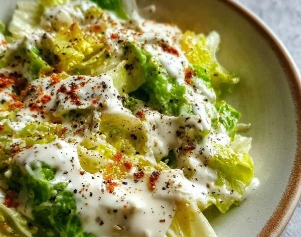 Creamy Greek Yogurt Caesar Dressing served in a bowl with fresh ingredients