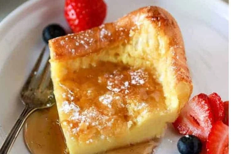 Fluffy German pancakes served with fresh fruit and syrup.