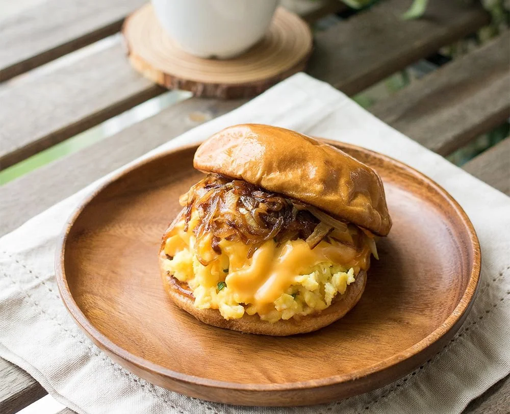Eggslut Signature Breakfast Sandwich featuring egg, cheese, and toppings on a fresh bun.