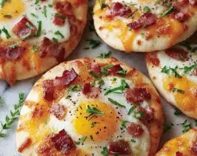 Delicious English Muffin Breakfast Pizza topped with eggs and cheese