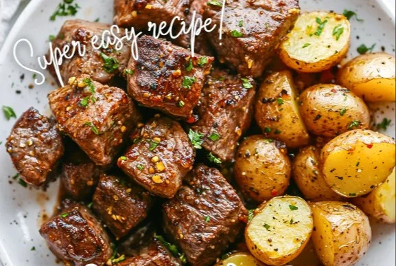 Delicious Garlic Steak Bites with Potatoes on a plate