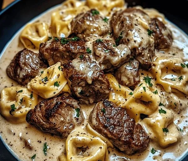 Delicious plate of Garlic Steak Tortellini with fresh herbs and sauce