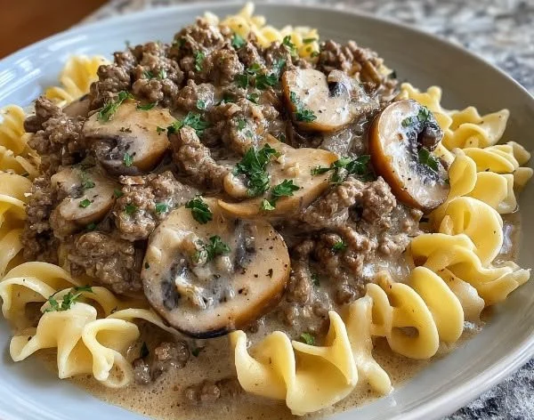 Delicious Ground Beef Stroganoff served with noodles and garnished with parsley