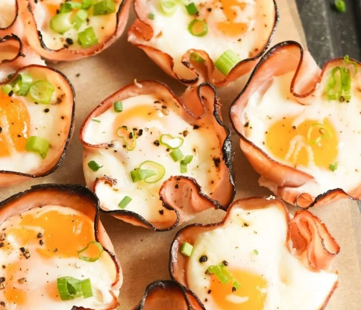 Ham and cheese egg cups ready to serve, a delightful breakfast option.