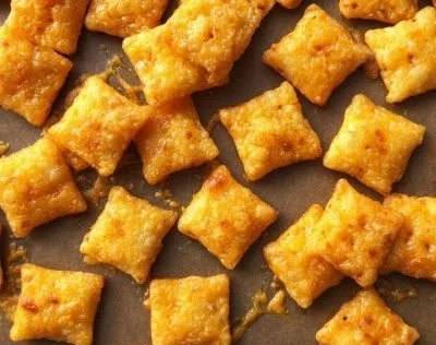 Homemade Cheez-Its fresh out of the oven, golden brown and cheesy.
