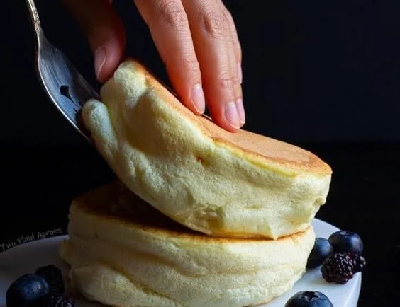 Fluffy Japanese Souffle Pancakes stacked with syrup and fruits