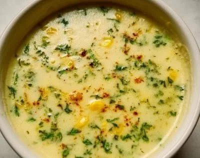 Delicious bowl of Lemon Artichoke Soup garnished with fresh herbs