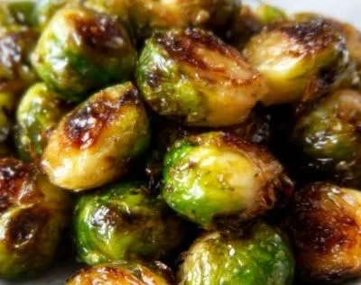 Maple-glazed roasted Brussels sprouts drizzled with syrup for added flavor.