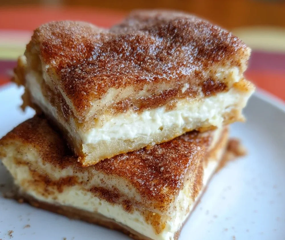 Mexican-inspired churro cheesecake bars topped with cinnamon sugar