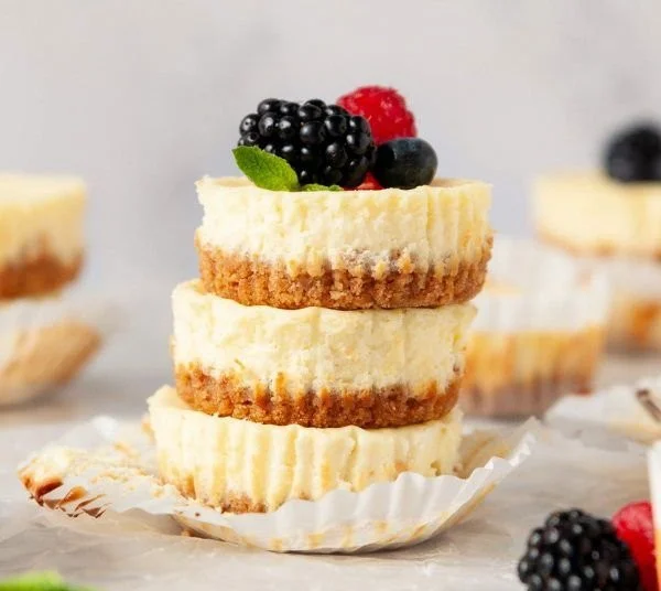 Mini protein cheesecakes topped with fresh berries, healthy and gluten-free dessert