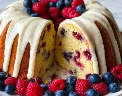 Mixed Berry Bundt Cake with Lemon Glaze on a white plate