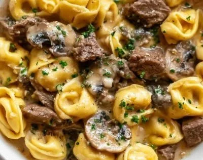 Philly Cheesesteak Tortellini dish featuring cheese, steak, and pasta.