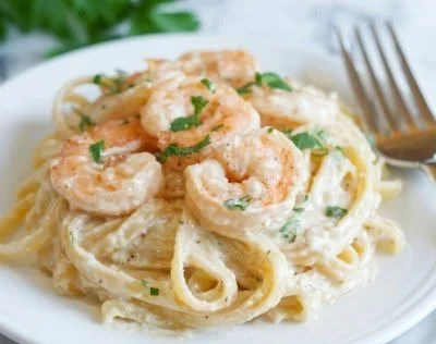 Delicious bowl of Shrimp Fettuccine Alfredo with creamy sauce and herbs