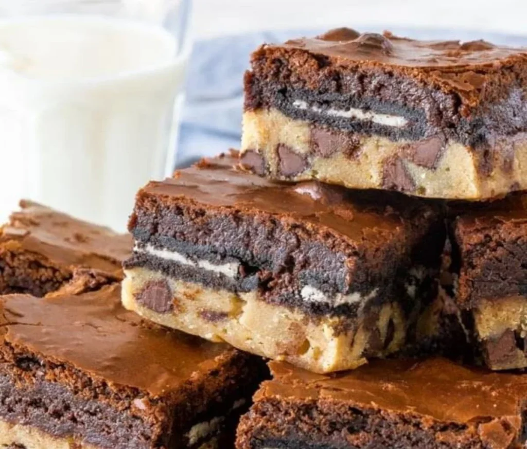 Delicious slutty brownies with layers of cookie dough, Oreos, and chocolate brownie.