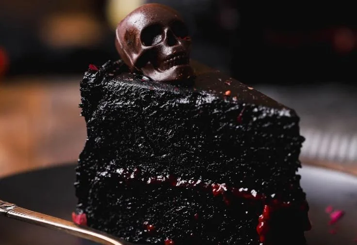 Spooky Black Velvet Cake decorated for Halloween with ghostly toppings