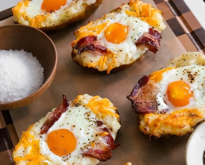 Twice-baked breakfast potatoes loaded with toppings, perfect for a hearty breakfast.