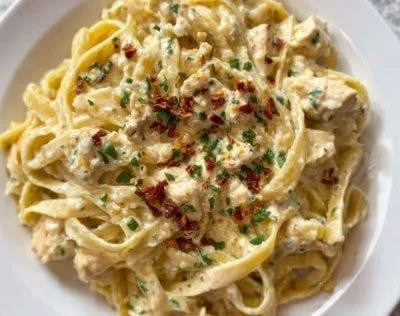 Vegan gluten-free Alfredo sauce in a bowl with ingredients around it
