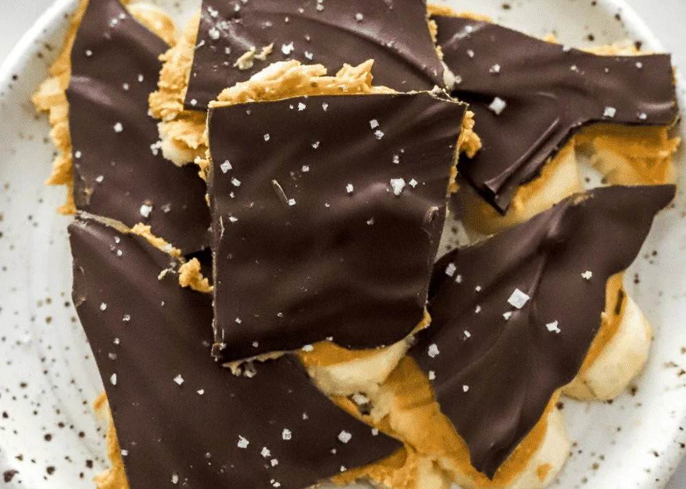 Viral chocolate banana bark with slices of banana on a tray