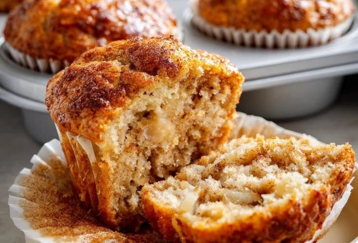 Banana Greek yogurt muffins topped with cinnamon on a wooden table