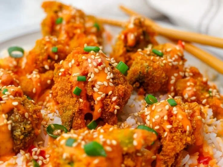 Delicious Bang Bang Broccoli served on a plate with vibrant colors and garnishes.