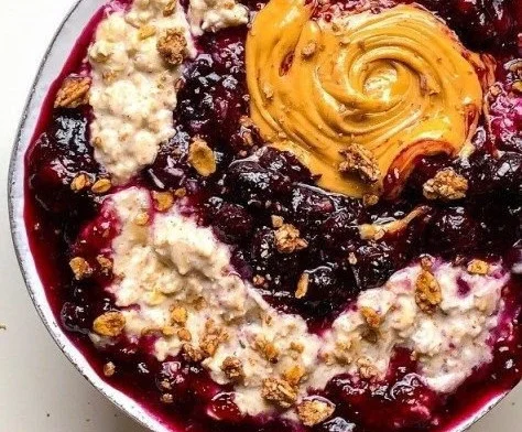 Delicious blueberry pie overnight oats in a bowl with fresh blueberries on top.