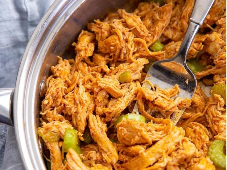 Buffalo-style chicken lettuce wraps with fresh vegetables