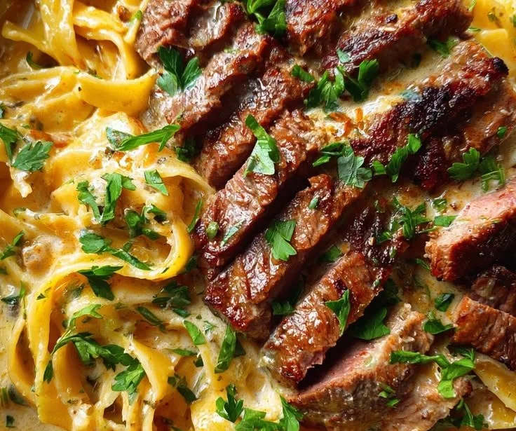 Creamy pepper jack garlic butter steak pasta dish garnished for comfort food meal
