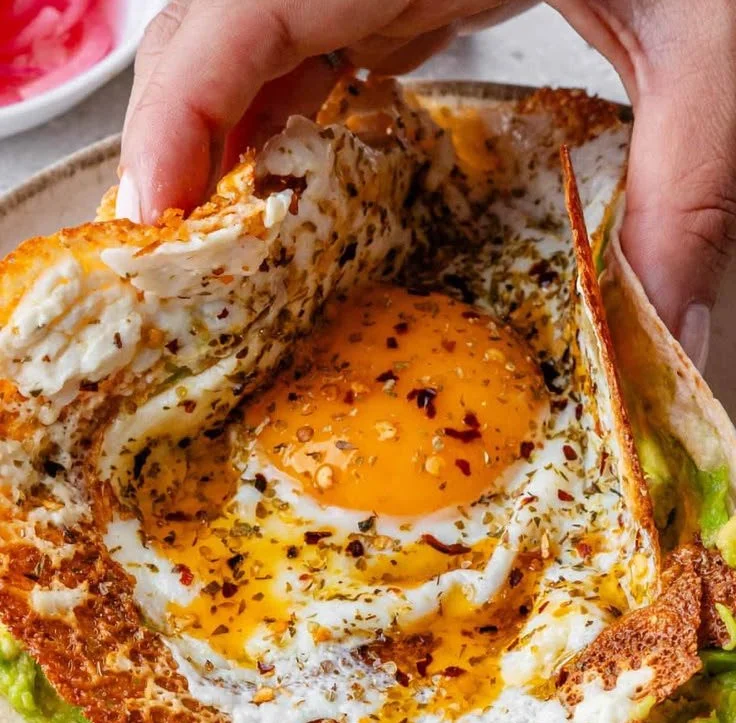 Crispy feta fried eggs with golden brown edges served on a plate