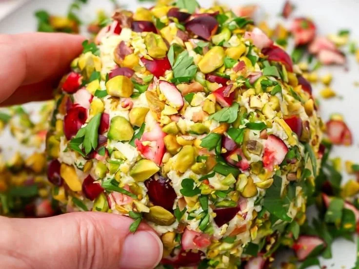 Delicious homemade vegan cheese ball served with crackers and herbs