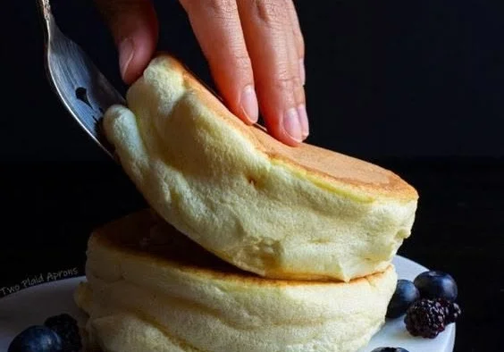Delicious fluffy Japanese soufflé pancakes stacked on a plate
