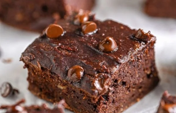 Gluten-free flourless pumpkin brownies on a plate with fall decorations.