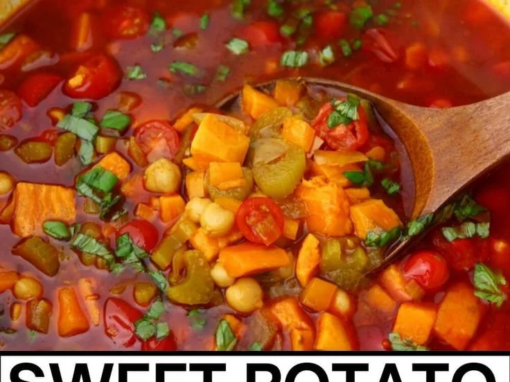 Gluten-free vegan vegetable soup in a bowl topped with fresh herbs.