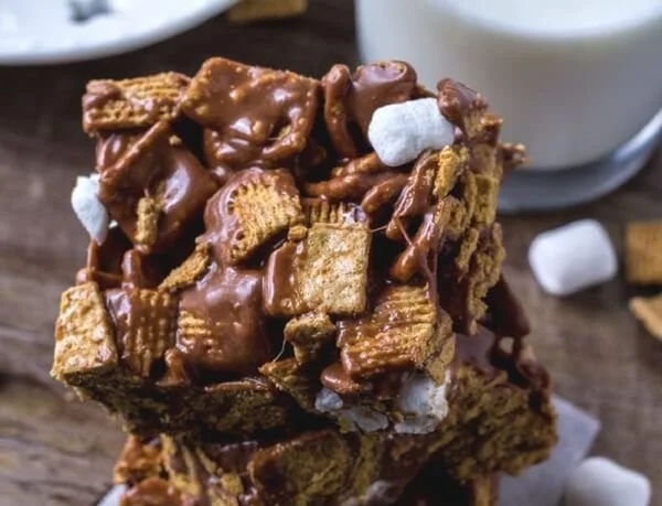 Delicious Golden Grahams S'mores Bars garnished with chocolate and marshmallows.
