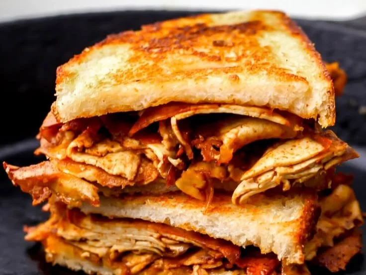 Delicious grilled tofu sandwich served with fresh vegetables and sauce