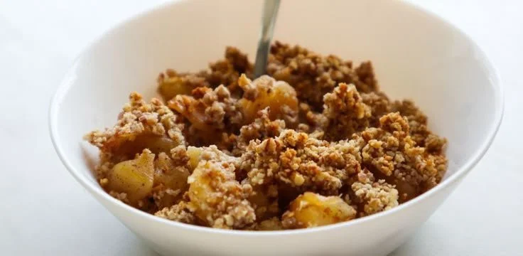 Healthy apple crumble served in a bowl for a nutritious breakfast option.