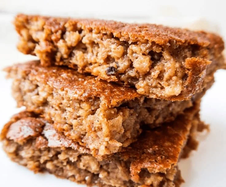 Healthy flourless oatmeal apple cake topped with fresh apples and cinnamon