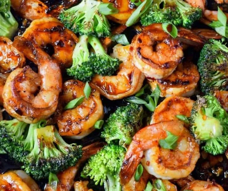 Delicious honey garlic butter shrimp served with herbs and rice