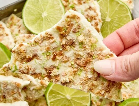 Delicious Key Lime Pie Yogurt Bark garnished with lime zest and served on a platter.
