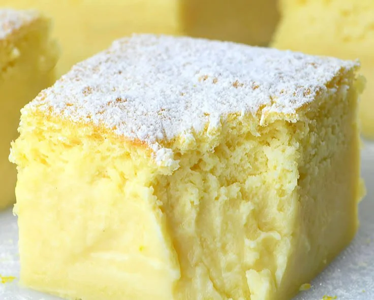Delicious slice of lemon custard cake topped with fresh lemon zest.