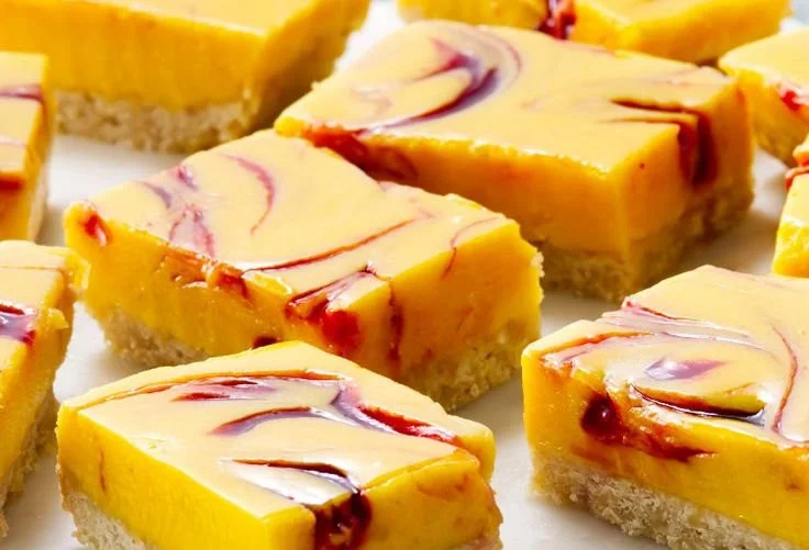 Delicious mango curd bars topped with fresh mango slices and mint leaves
