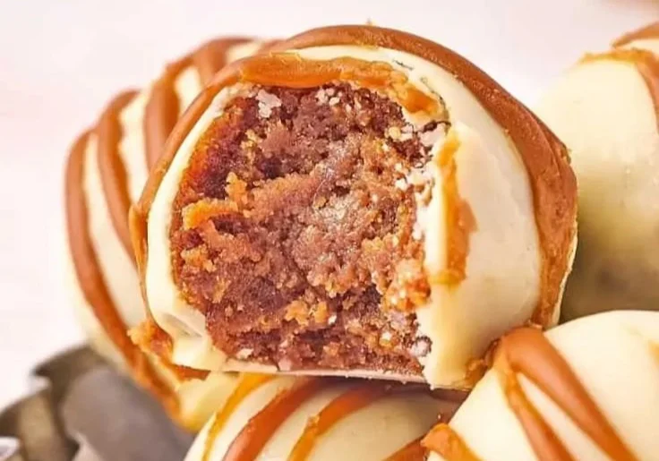 Delicious no-bake Biscoff truffles on a white plate.