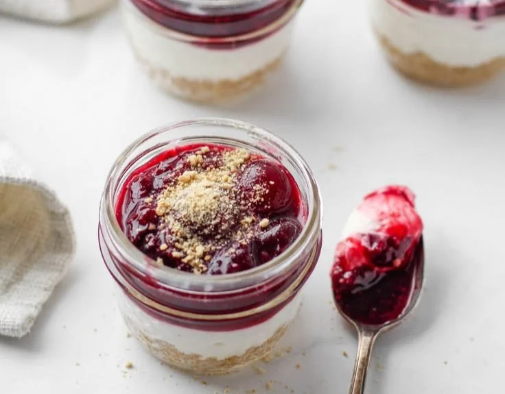 Healthy no bake cheesecake in a jar topped with fresh berries